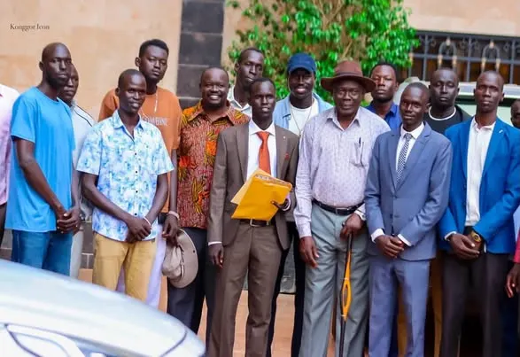 Musician Deng Lok poses with Tonj community leaders during the handover ceremony of a vehicle in Juba. Photo: Courtesy