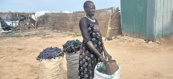 A woman selling three sacks of charcoal at Turalei Market in Twic County, Warrap State. (Image Credit: Majok Kuol/Twic Media Reports)